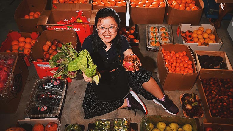 Ms Yeo Pei Shan, co-founder of UglyFood showcasing imperfect fruits and vegetables, which will be turned into juice and other products
