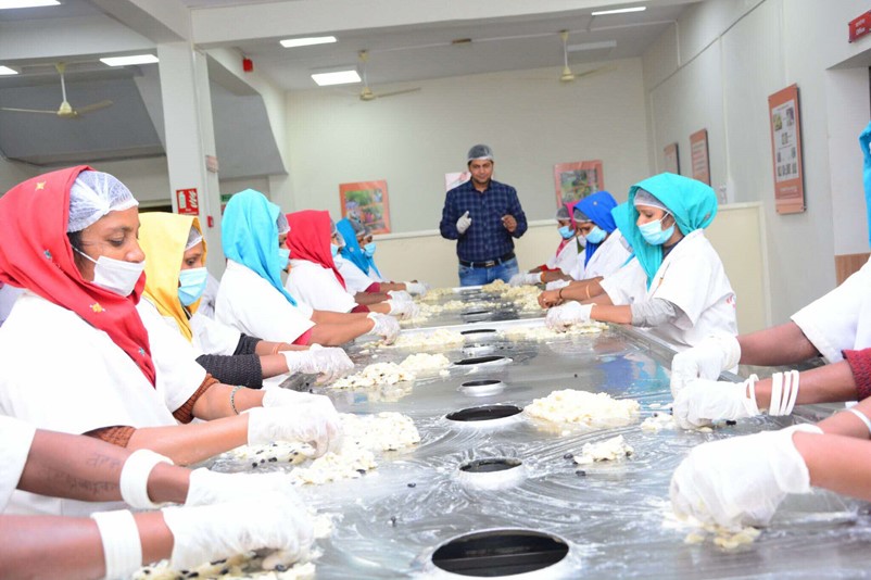 Tribal women processing custard apple