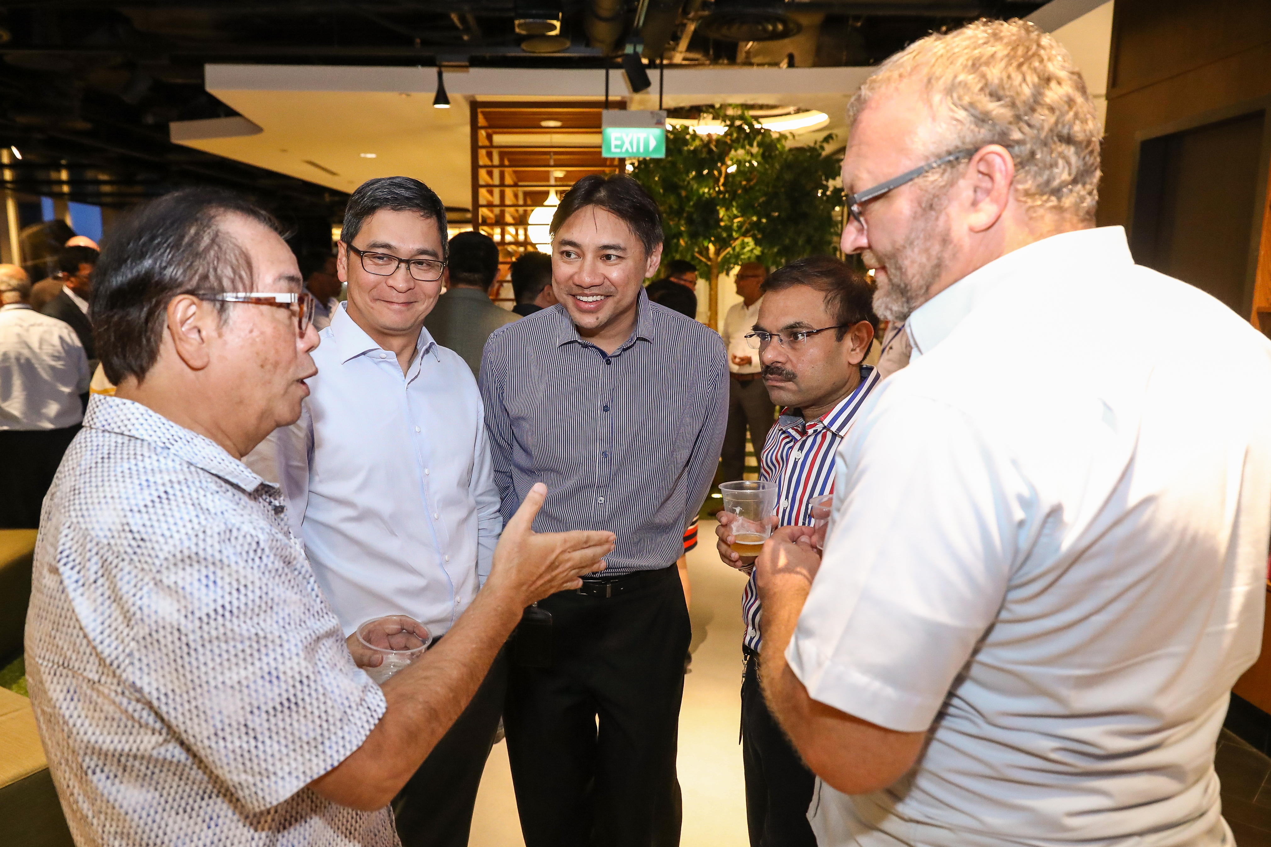Alfian (centre) in a conversation with DBS Chairman Peter Seah (left)